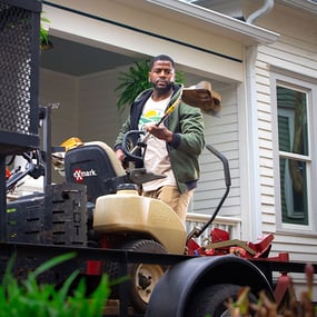 Landscaper in front of a customer's house