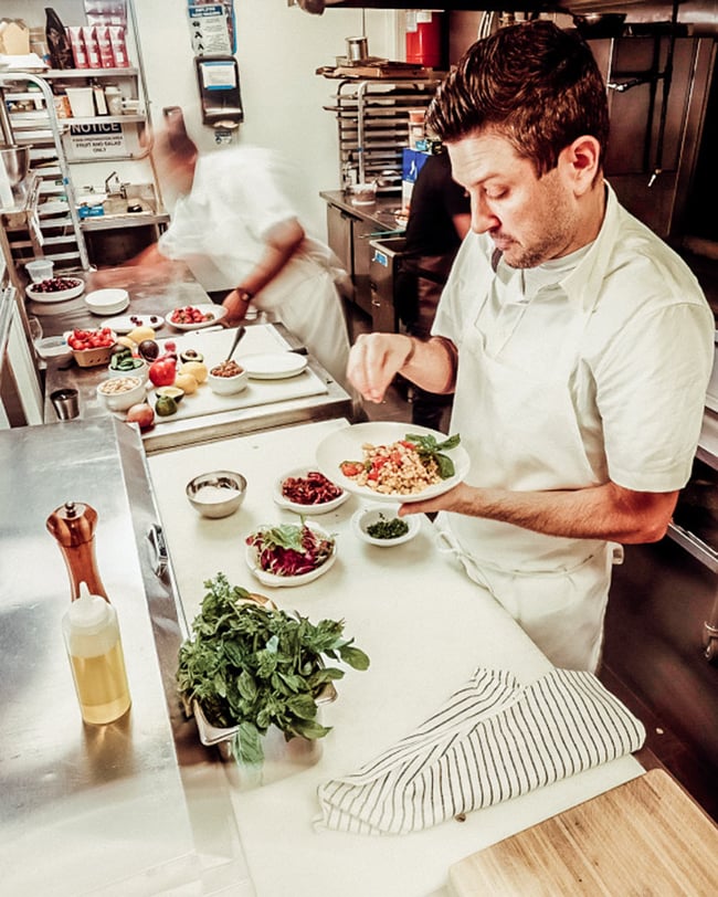 Kitchen staff plating dishes