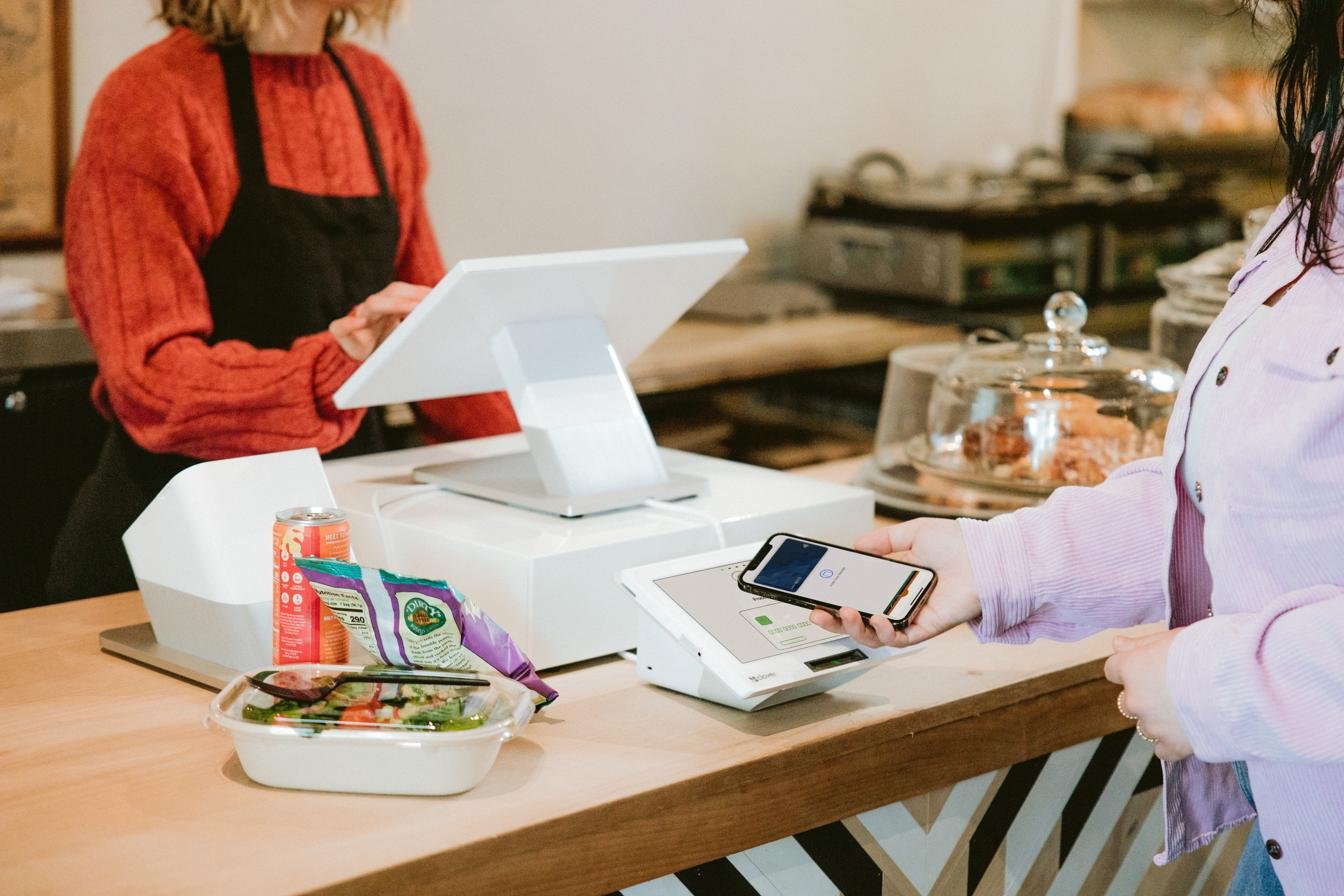 Customer paying for their order at a Clover Station Duo