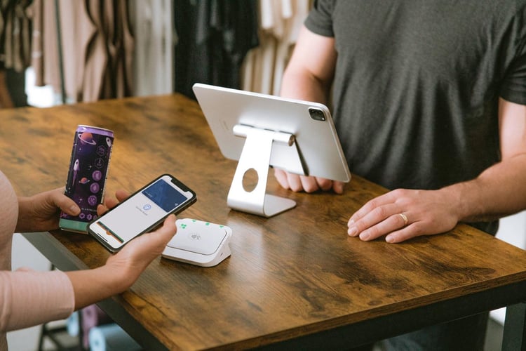 Clover Go on a countertop at a gym accepting payment via Apple Pay