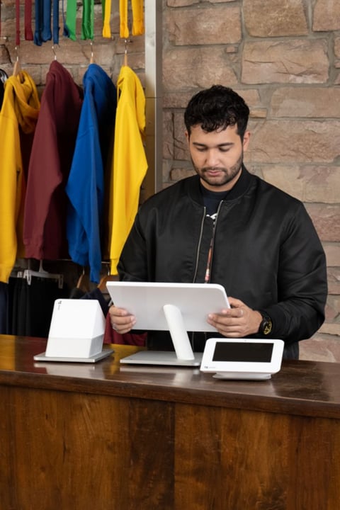 Employee behind a Clover Station Duo on the counter